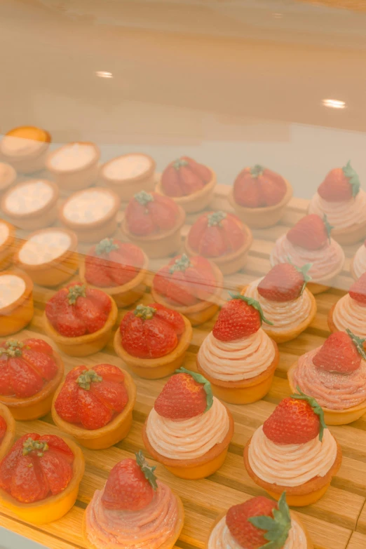 some little desserts sitting out on a wooden rack