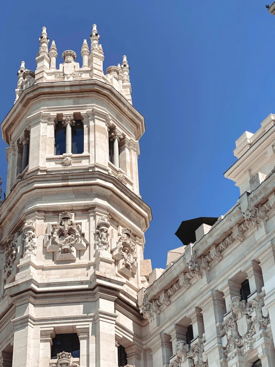 a large clock tower near many smaller buildings