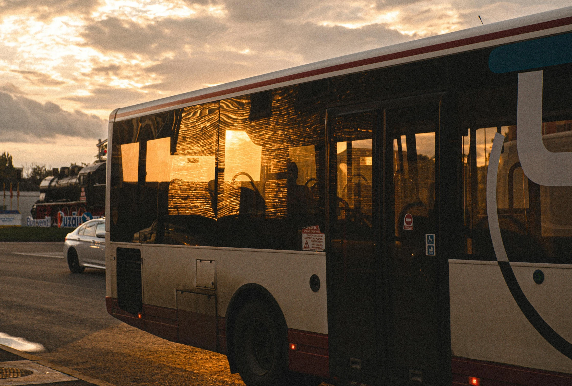 a city bus parked on the street next to a fence