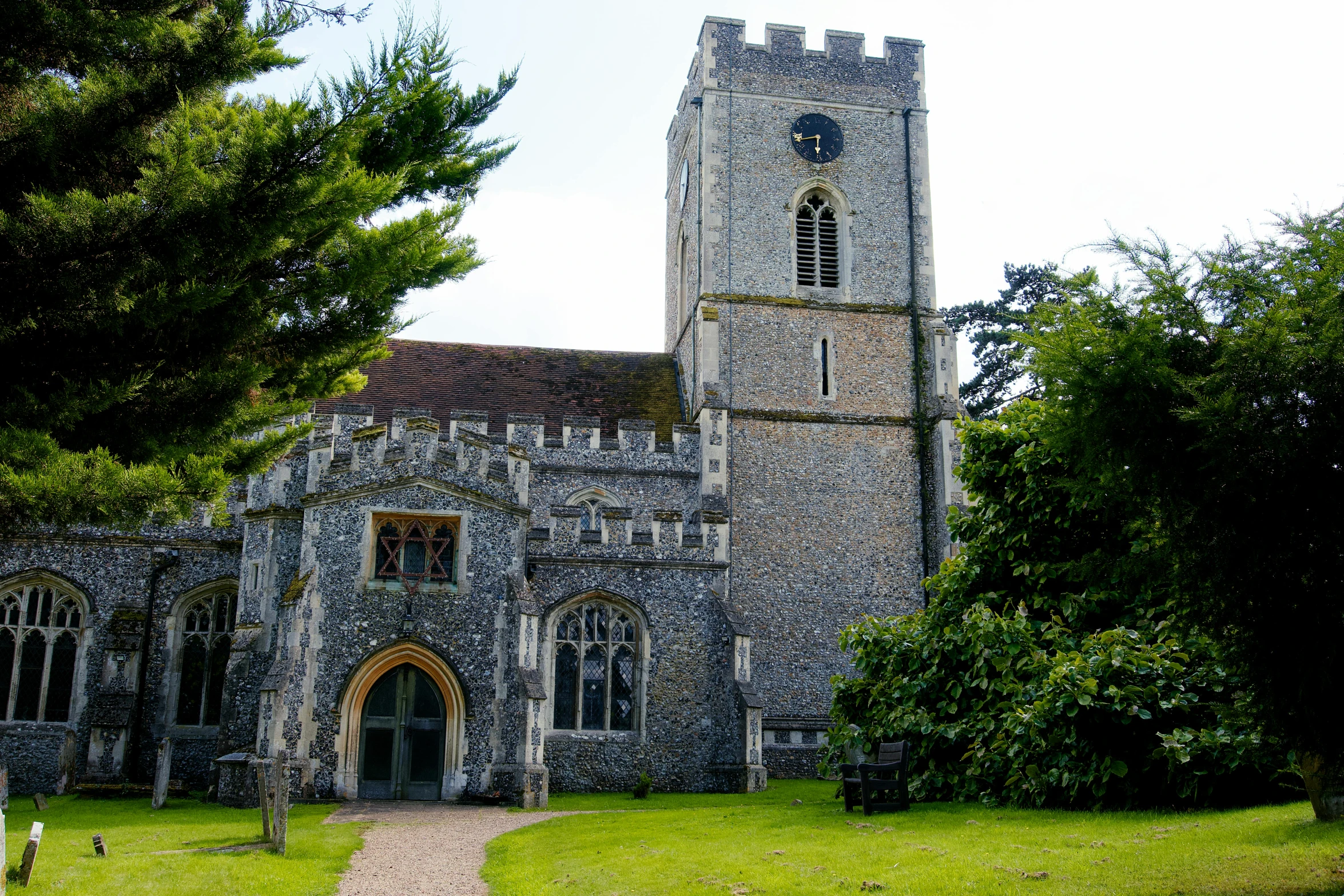 a church surrounded by lush green grass and trees