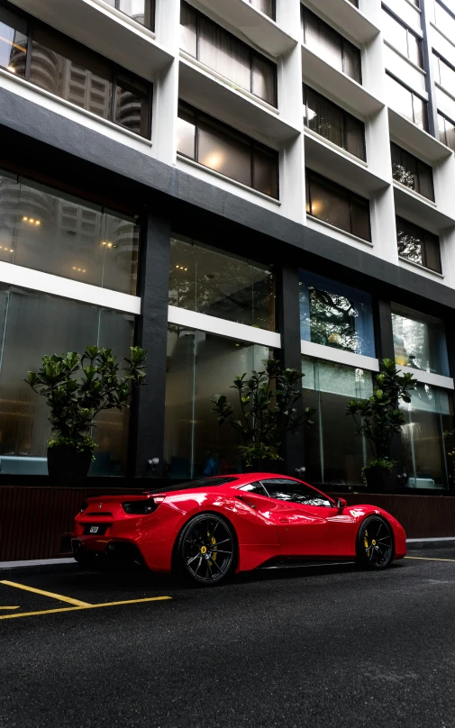 the red car parked on the side of the street