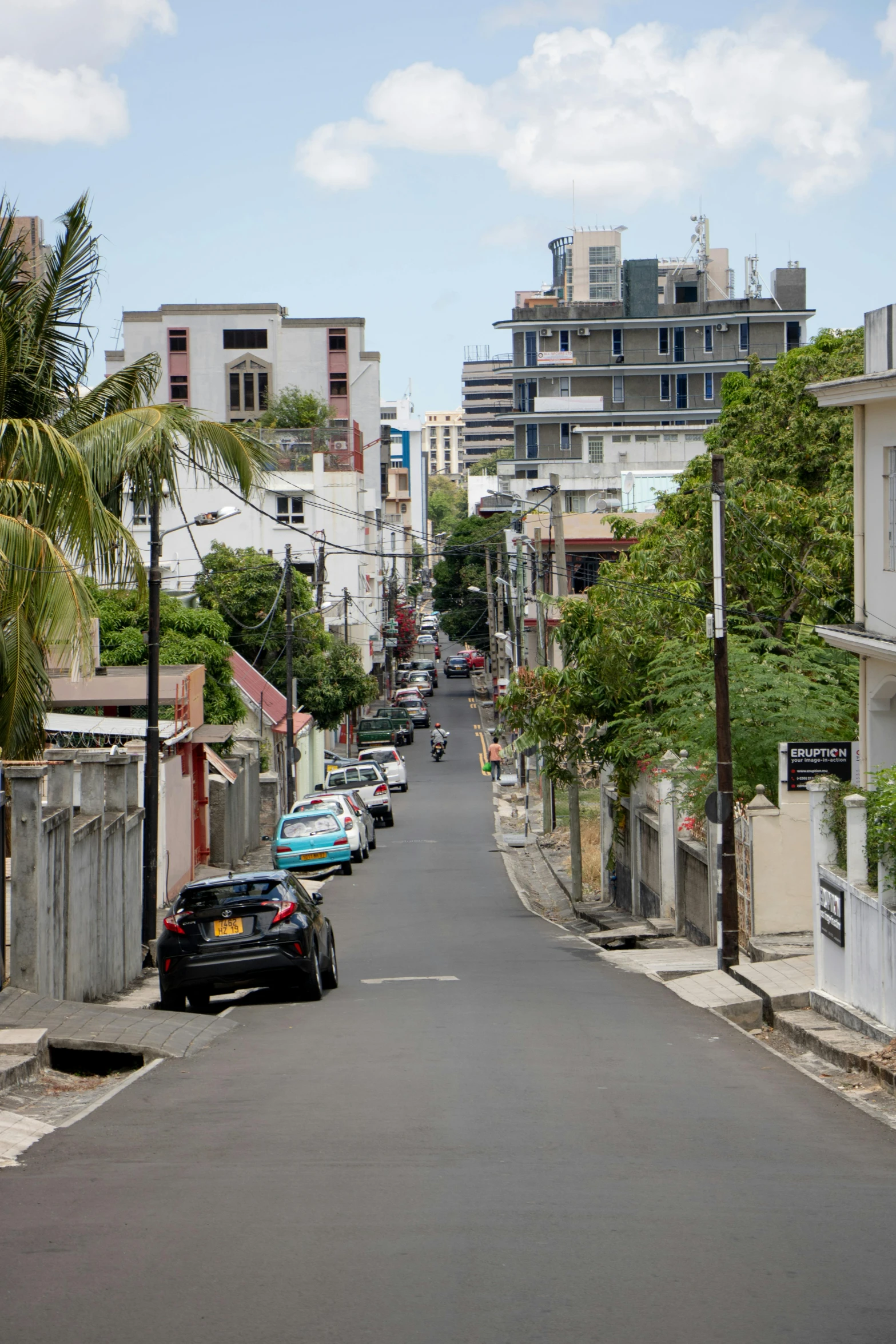 the narrow city road has many different buildings along it