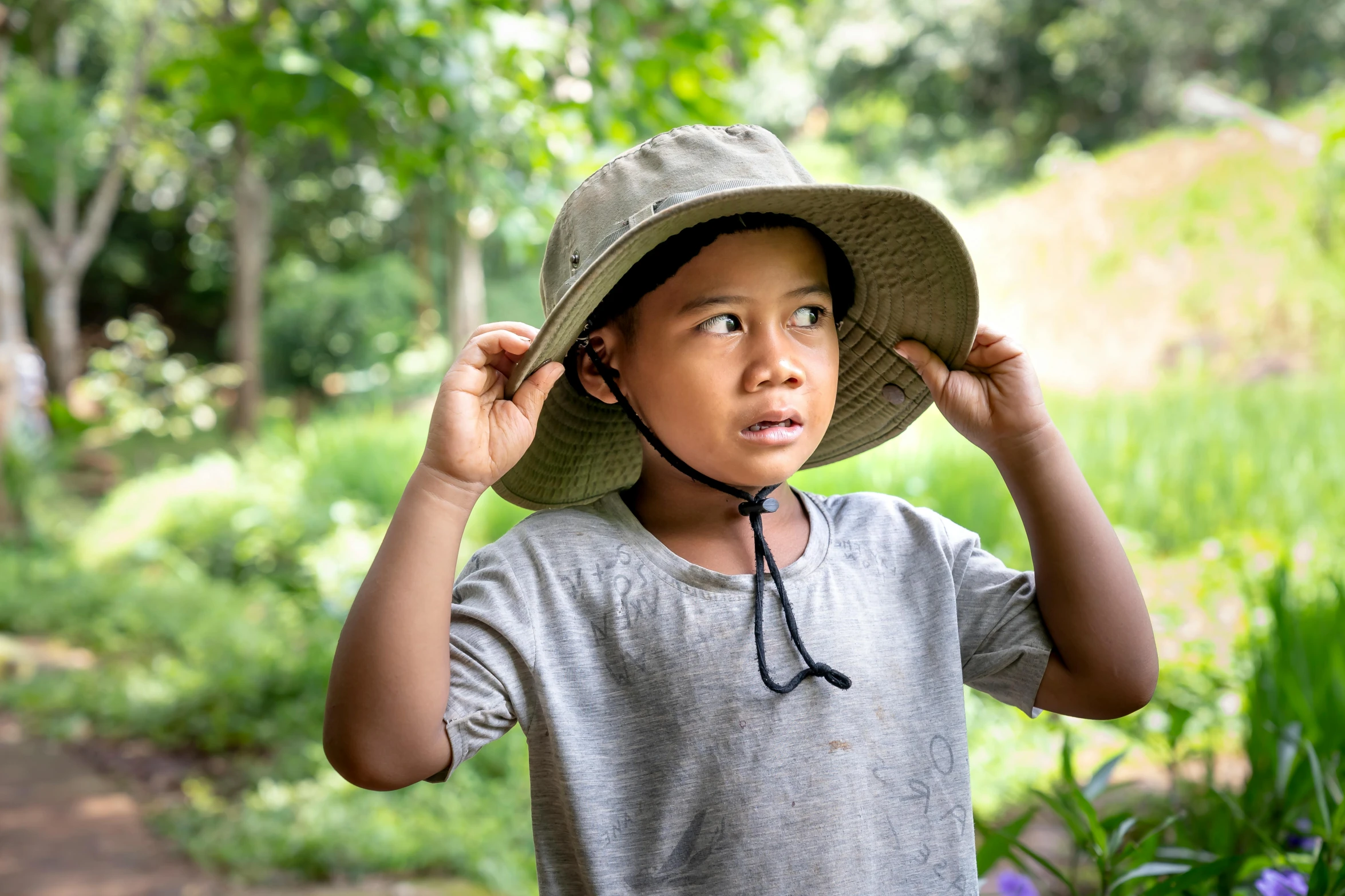 a  with a bucket hat is looking up into the sky