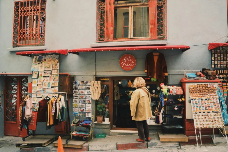 a person is standing outside a store with clothes