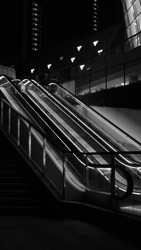 an escalator in a building near a walkway