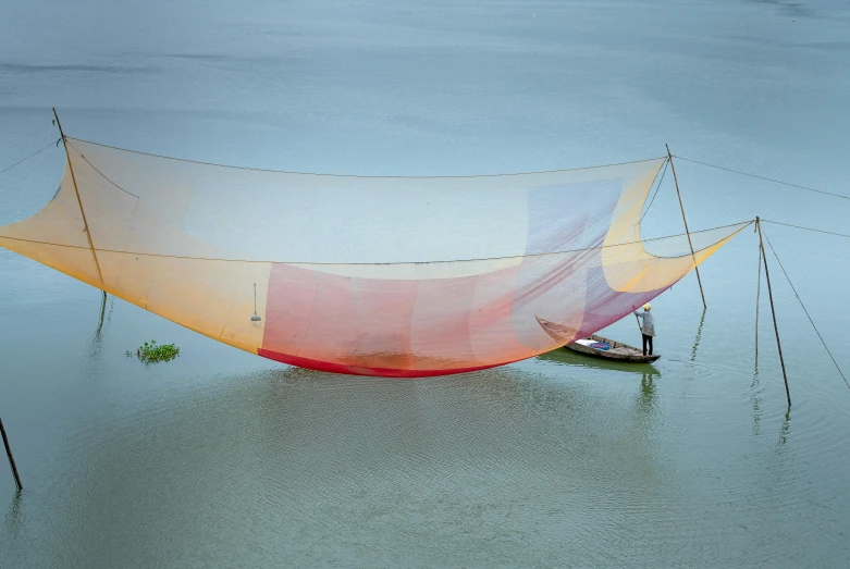 a boat sitting in the water with a very large covering over it