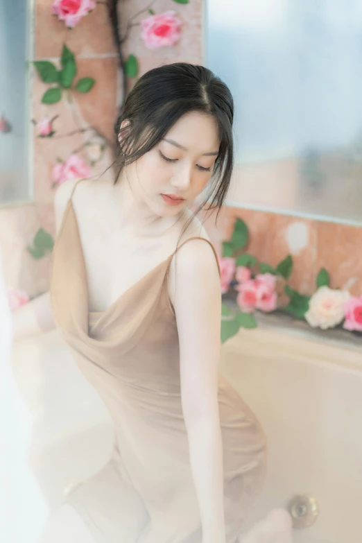 a girl posing for a po in front of a flowered wall