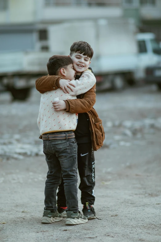 two boys on the street hugging each other