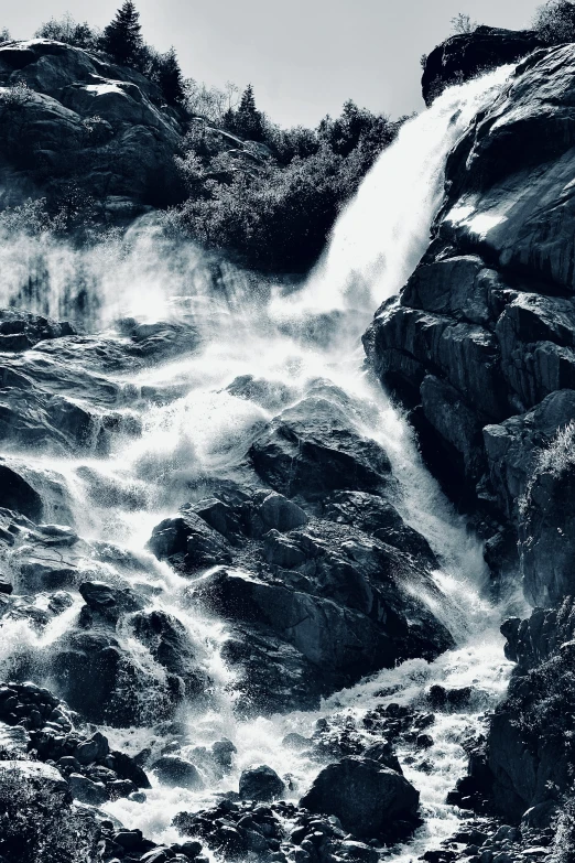 an up - close view of water rushing out of a very big waterfall