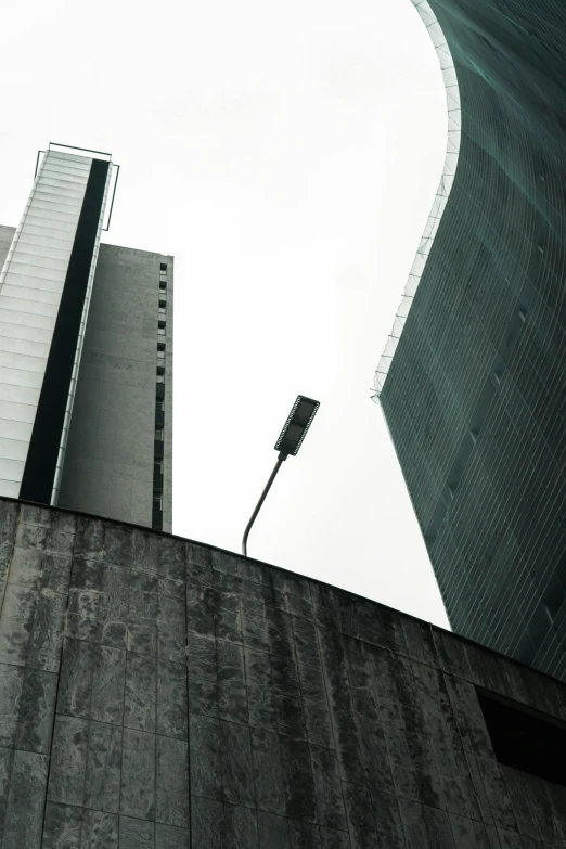 a traffic light attached to the side of a tall building