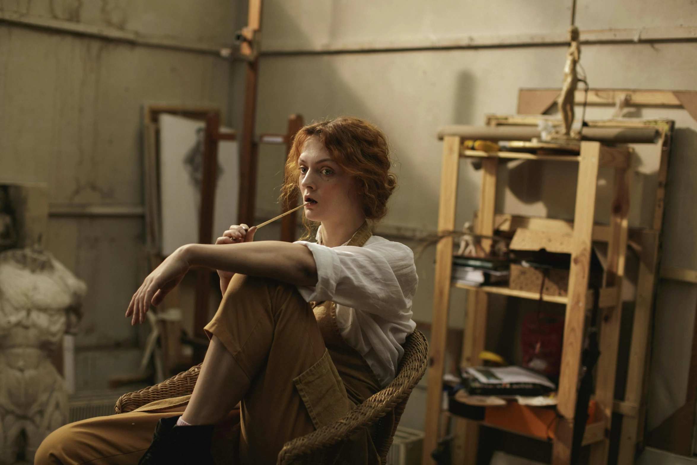 a woman is sitting in a chair with a toothbrush