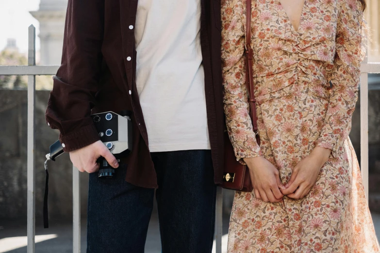 the man and woman stand together on the street