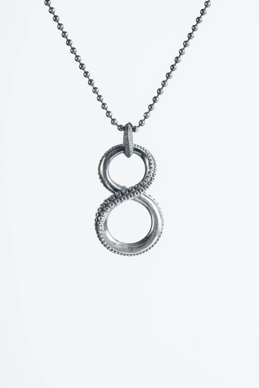 a necklace with an infinite sign hanging from it