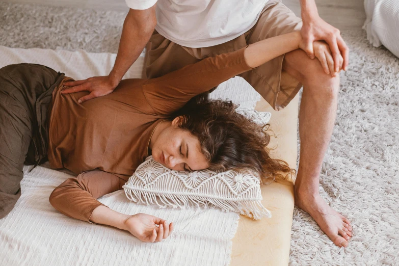 two people are laying on a rug in the living room