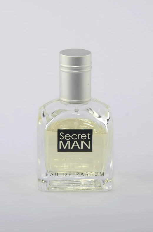 a white bottle of perfume with a black and white label