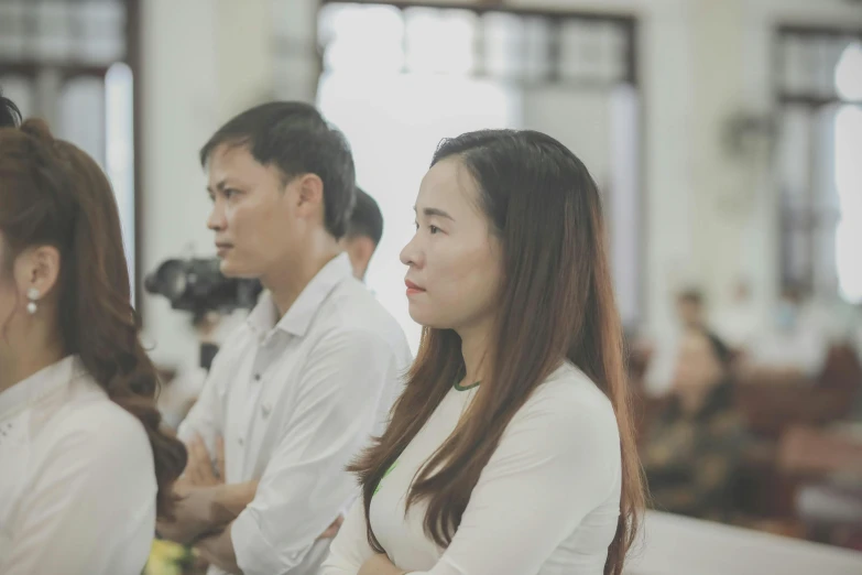 two woman and a man standing side by side