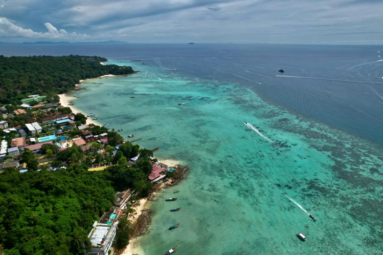 an aerial view shows boats moored at a resort area next to the ocean