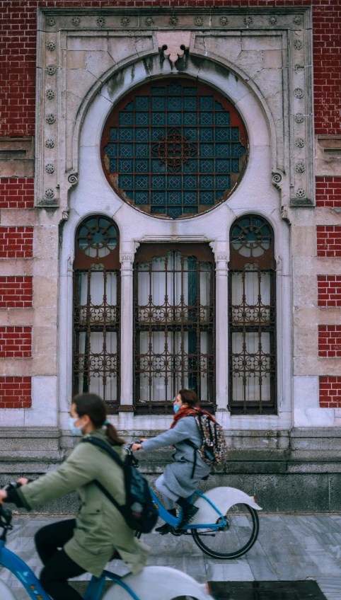 a  riding on a bicycle down a street