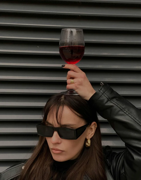 a woman holding up a glass of wine