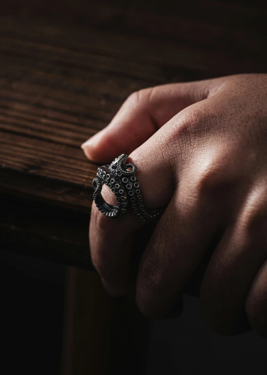 a person's hand resting on a table