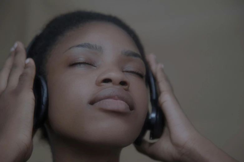 a close up of a person listening with headphones