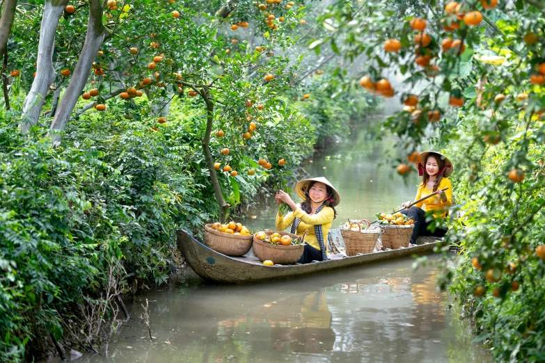 two women are riding in a canoe filled with fruit