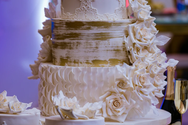 wedding cake with flowers and champagne glasses beside it