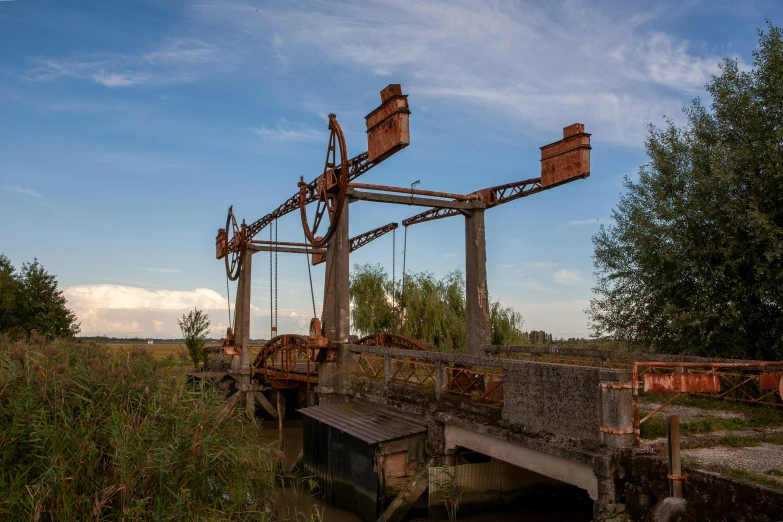 old water wheel near wooden bridge in the wild