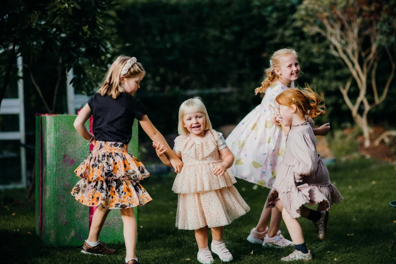 some very cute small girls holding hands