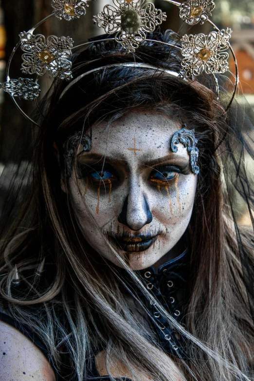 a woman with white paint painted on her face