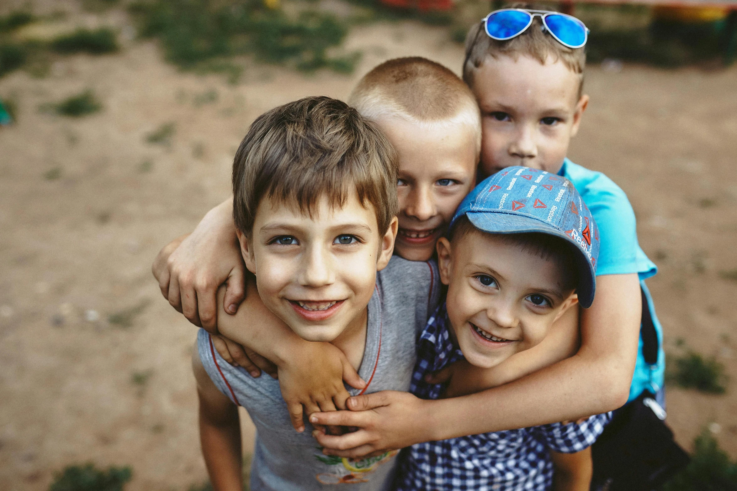 three small children posing for a picture with sunglasses