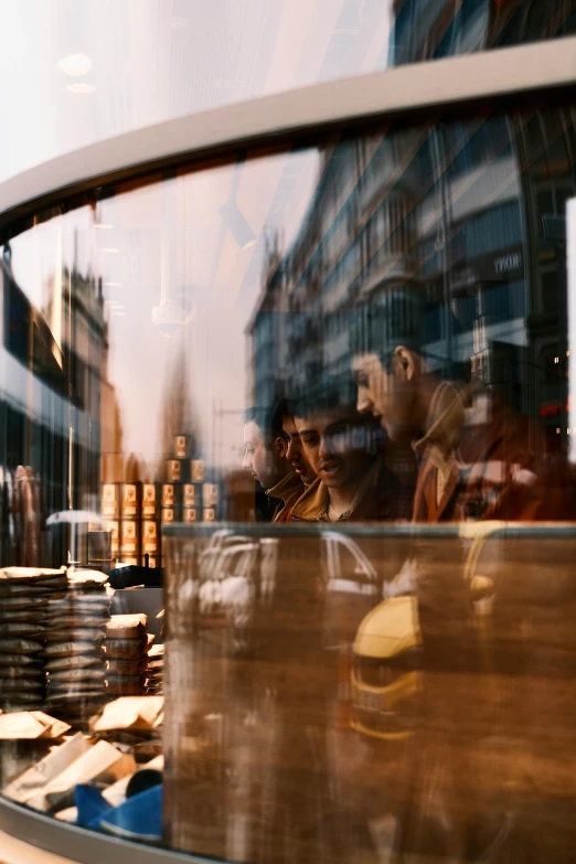 an old po of people standing near a bakery window