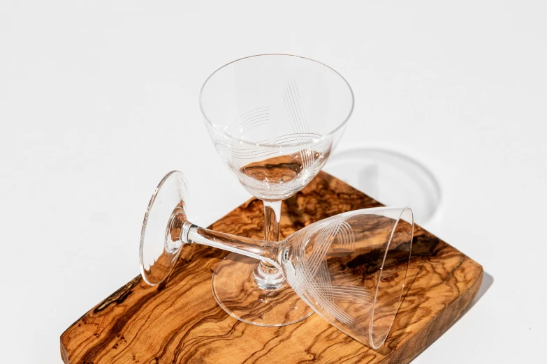 a wine glass on top of a wooden coaster