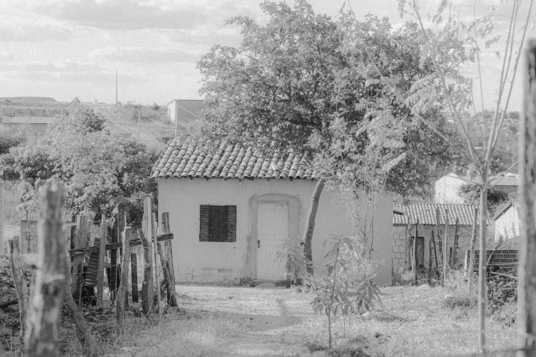 an old shack sitting in a dirt field