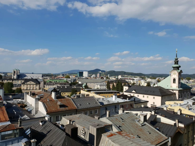 a view of a town with a blue sky and clouds