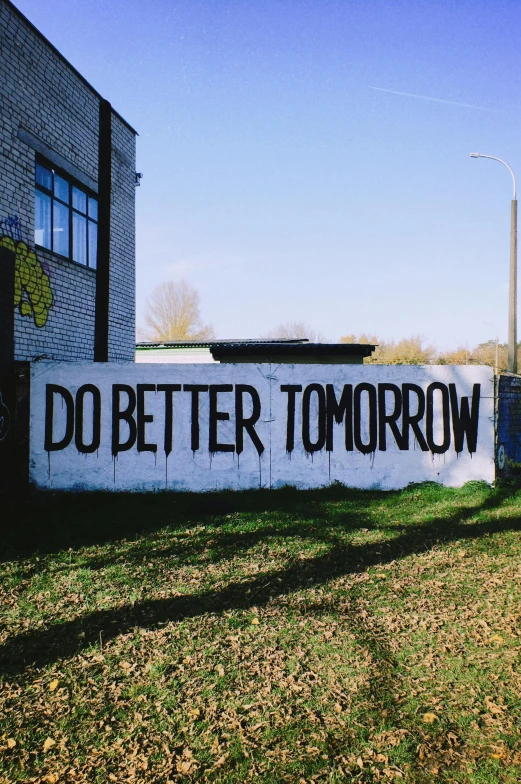 a do better tomorrow sign on the side of a building