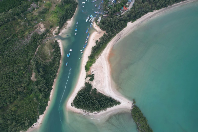 a bird's - eye view of boats on the water next to a shore