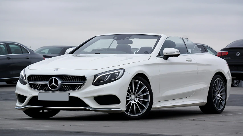 a white mercedes s coupe is shown with a helmet on