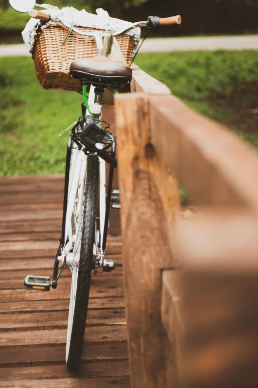 a bike is locked up against a wooden bridge