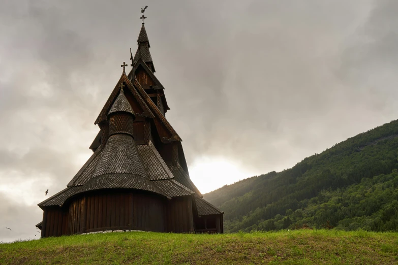 an old church sits in a grassy field