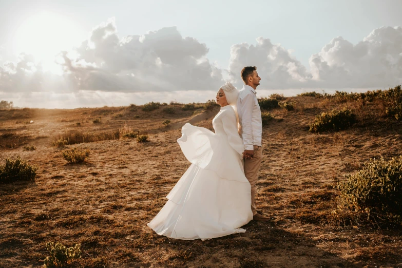 a man and a woman are walking in a field