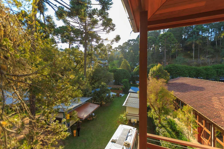 a picture taken from the back porch of a house looking down on an outside lawn and picnic tables