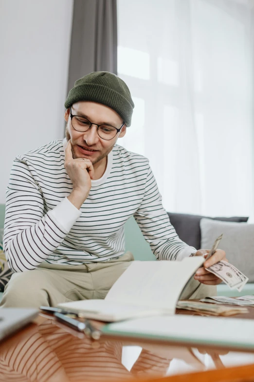 there is a man sitting at a desk working on a computer