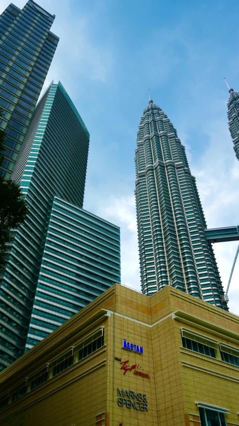 very tall buildings in a large city with blue sky in background