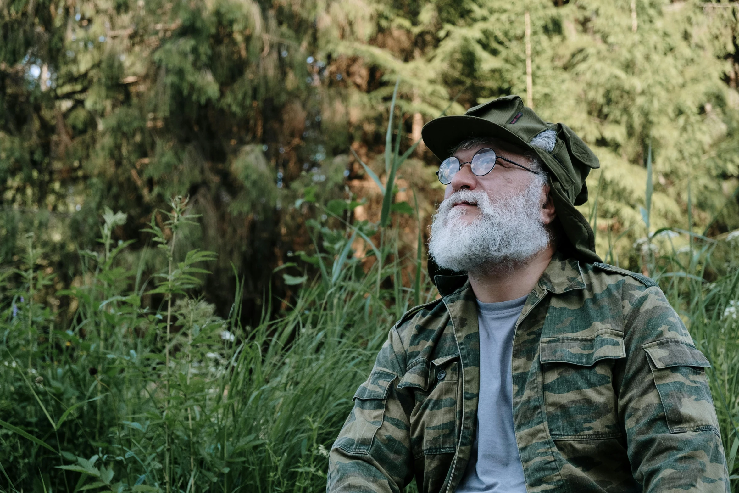 an older man with a goatee, glasses and hat