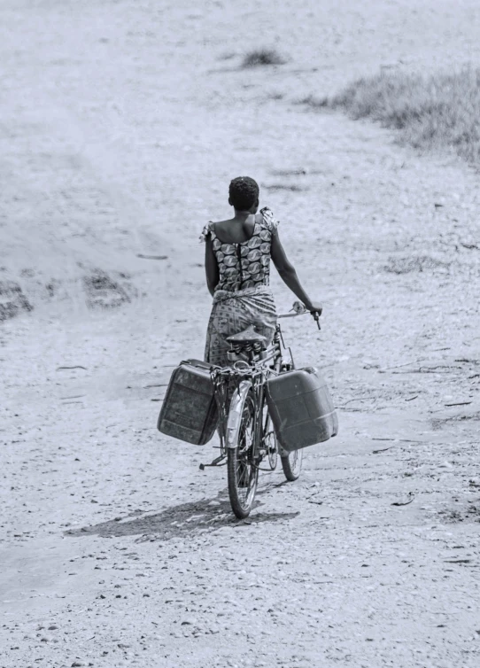 a woman with luggage bags riding on her bike