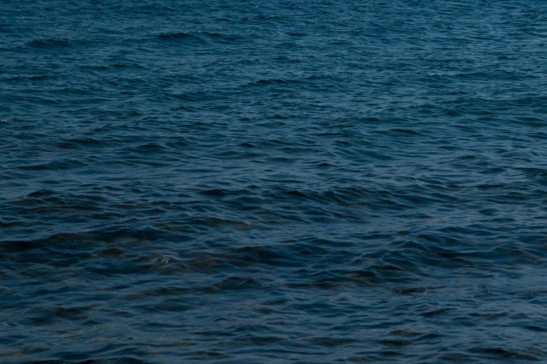 an airplane in flight over choppy waters