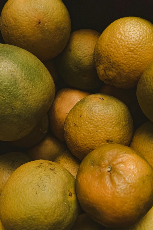 a pile of citrus fruits on display in a container