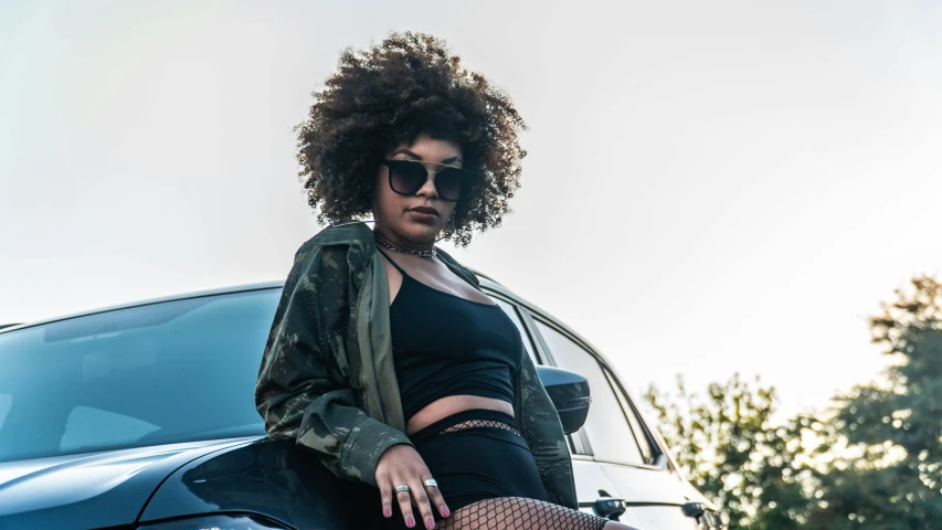 an image of woman posing for the camera on a car