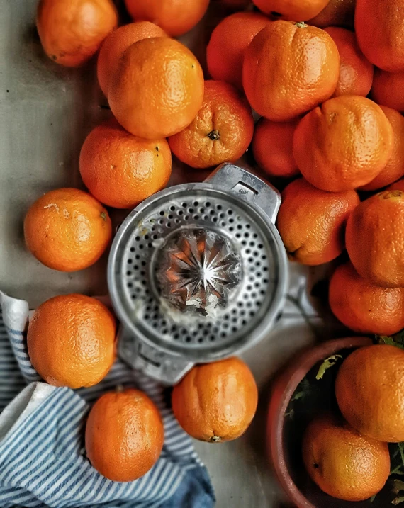 many oranges laying around and one is in a sink